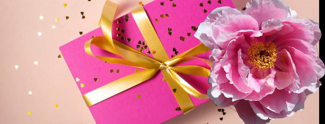 big pink flower with pink gift box and a yellow bow